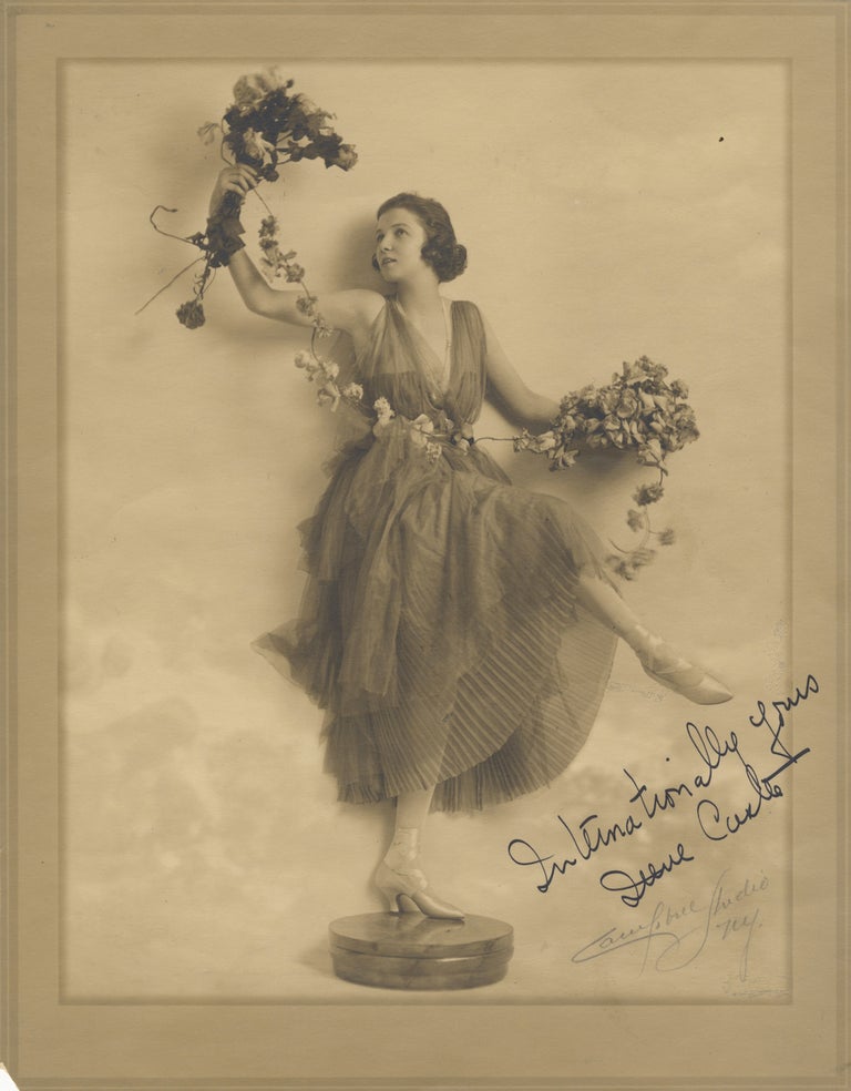 Item #29400 Fine full-length original photograph of the noted ballroom dancer in costume, posed on a pedestal holding flowers in each hand linked by a single floral strand. Signed in ink at lower right: "Internationally yours Irene Castle," with "Campbell Studio NY." in pencil below. Irene CASTLE.