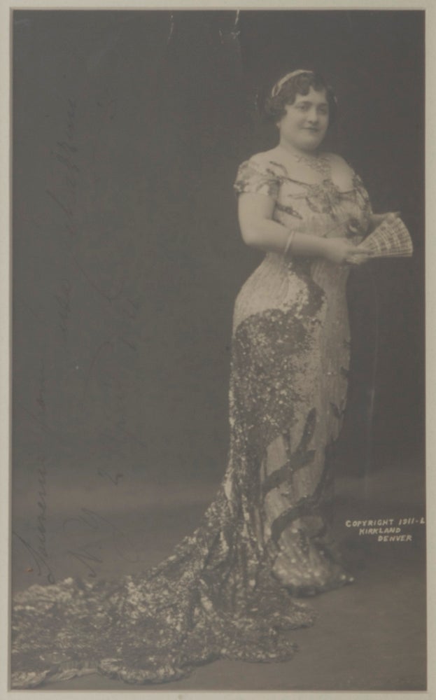 Item #30322 Large full-length photograph of the noted coloratura soprano in long dress with train, holding a fan, possibly a role portrait. With autograph inscription "Souvenir from Luisa Tetrazzini N.Y. 2 April 1911" in black ink running vertically along left portion of image. Luisa TETRAZZINI.
