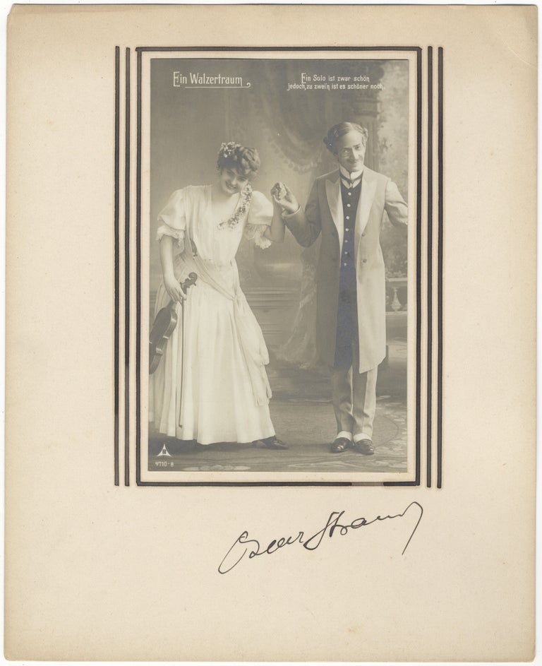 Item #30818 Autograph signature on mount below vintage postcard photograph of characters from the composer's operetta "Ein Walzeertraum." Oscar STRAUS.