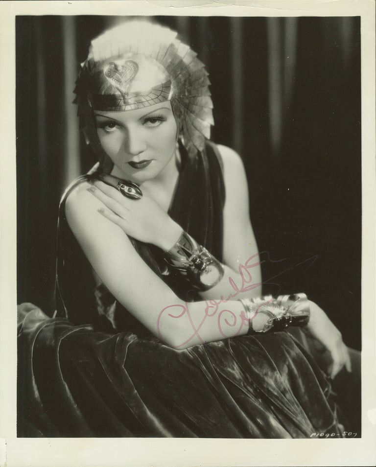 Item #35418 Three-quarter length photograph of the French-born American stage and film actress, signed in full. Claudette COLBERT.