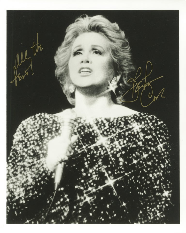 Item #35421 Half-length photograph of the American actress and singer holding microphone, inscribed "All the best!" and signed in full in gold ink. Barbara COOK.