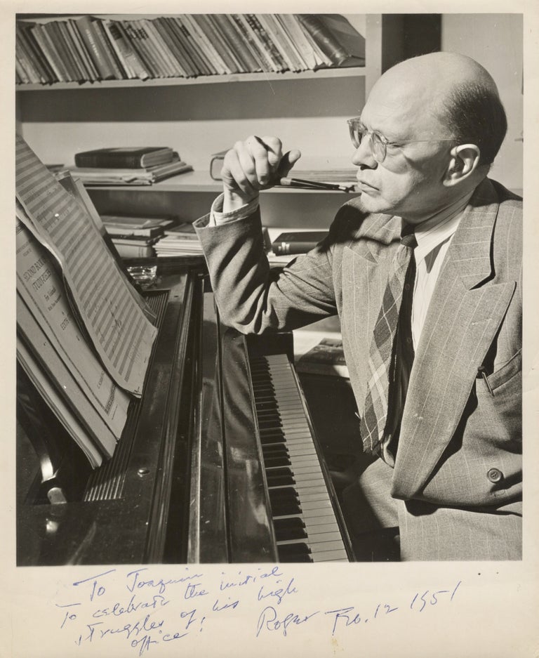 Item #39025 Photograph of Sessions seated at the piano, pen in hand, with sheets of manuscript paper before him. Signed and inscribed to fellow composer Joaquín Nin-Culmell. Roger SESSIONS.