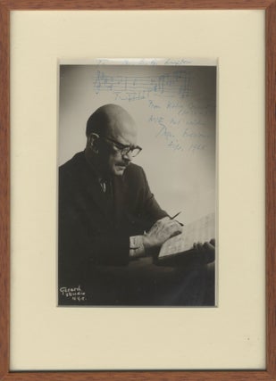 Photograph of the composer, manuscript in hand, with autograph musical quotation from his Violin Concerto signed in full