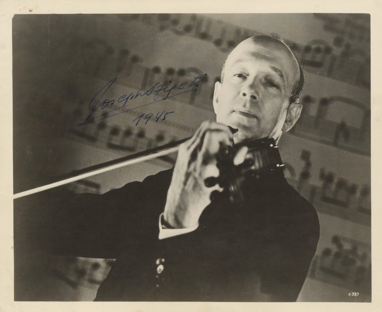 Item #39132 Half-length glossy publicity photograph of the noted violinist bowing his instrument. Joseph SZIGETI.