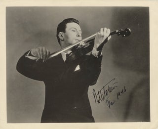 Item #39133 Half-length glossy publicity photograph of the noted violinist bowing his instrument....
